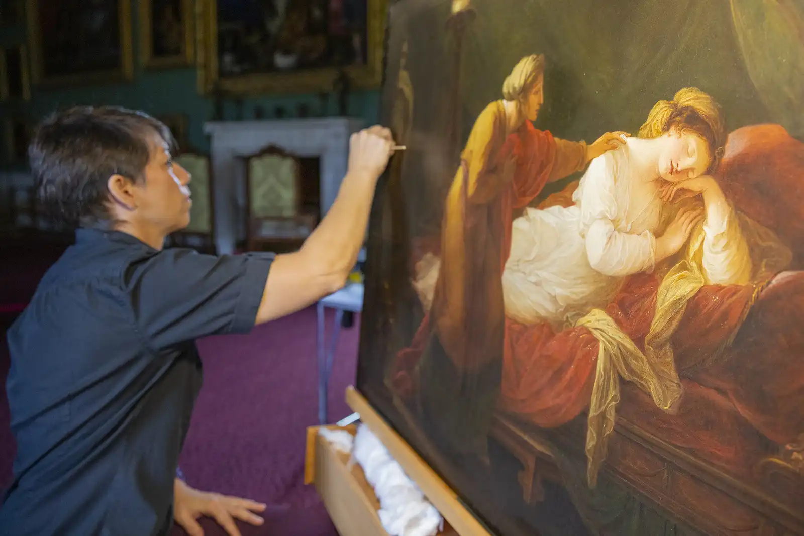 Painting conservator, April Johnson, works on the painting. Picture: National Trust Images/James Dobson
