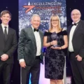 Kirsty Allen and Graham Hart from Harts of Stur collect the award from John Grayson, middle left, and Comedian and host Jake Lambert, left