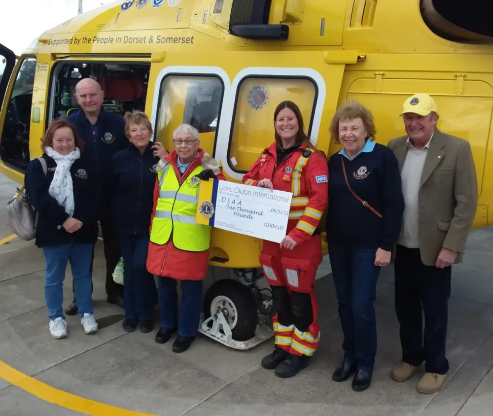 Lions president Janet Godden presenting the cheque to critical care practitioner, Lauren Dyson, alongside other group members