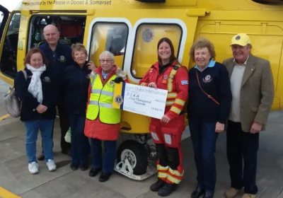 Lions president Janet Godden presenting the cheque to critical care practitioner, Lauren Dyson, alongside other group members