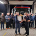 Chief fire officer Ben Ansell with Phil, surrounding by colleagues past and present. Picture: Blandford Fire Station
