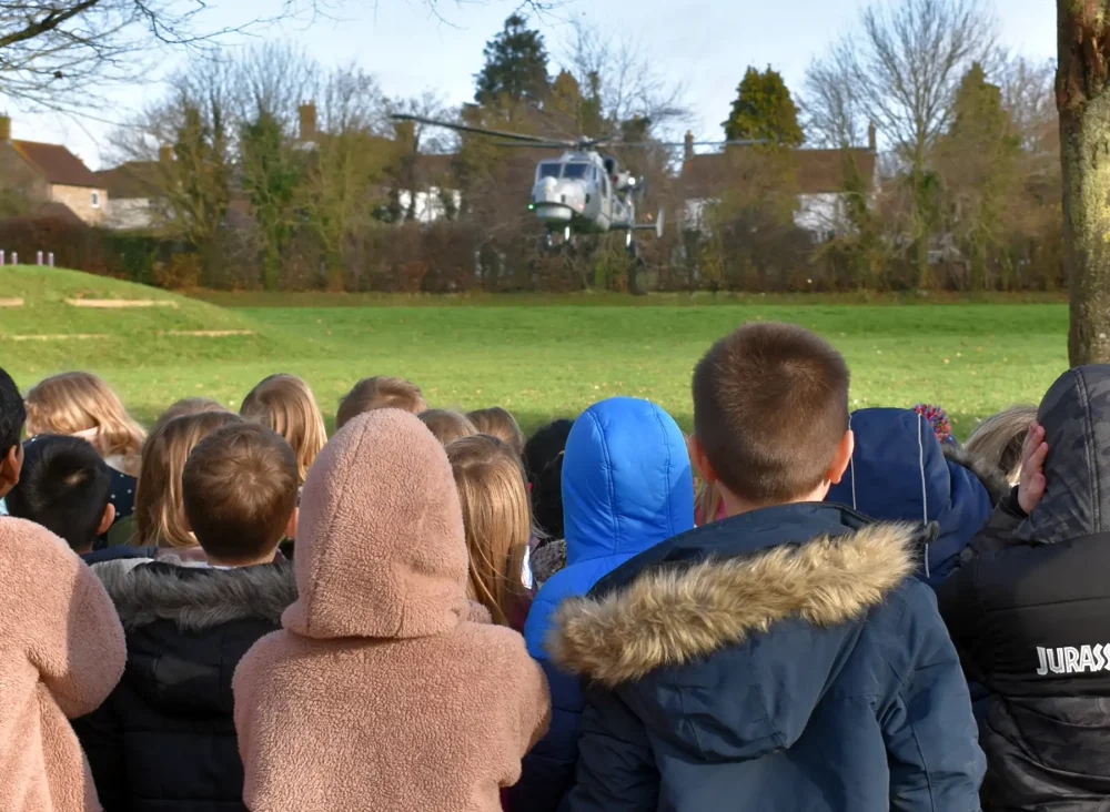 The helicopter lands on the playing field at Sherborne Primary School