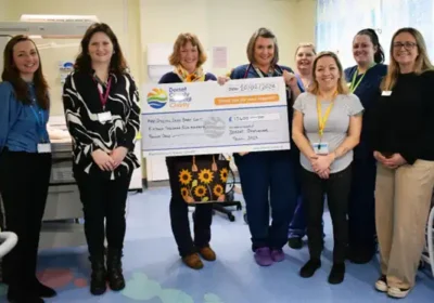 Hazel Hoskin presents a cheque for £15,400 to the Special Care Baby Unit at DCH