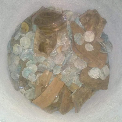 The coins were found in a pottery bowl, buried under the floor