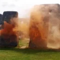 A person tried to stop the Just Stop Oil activists carrying out the attack at Stonehenge. Pictures: JSO