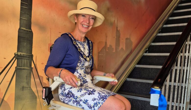 The Mayor of Sherborne Jill Warburton sitting on the new stair lift after cutting the ribbon to declare it ‘open’ for use Picture: SAYCC