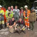 A suitably muddy Ruby with her rescuers Picture: Wiltshire Council
