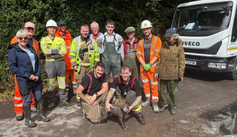 A suitably muddy Ruby with her rescuers Picture: Wiltshire Council