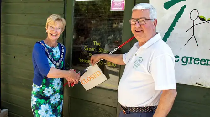 Mayor of Sherborne, Jill Warburton, and Antony Chambers, chairman of The Green Shed Sherborne, officially opening The Green Shed Sherborne at Castle Gardens