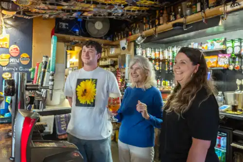 Shirley with bartenders Oscar Ashford and Chelsea Roper at The Digby Tap in Sherborne
