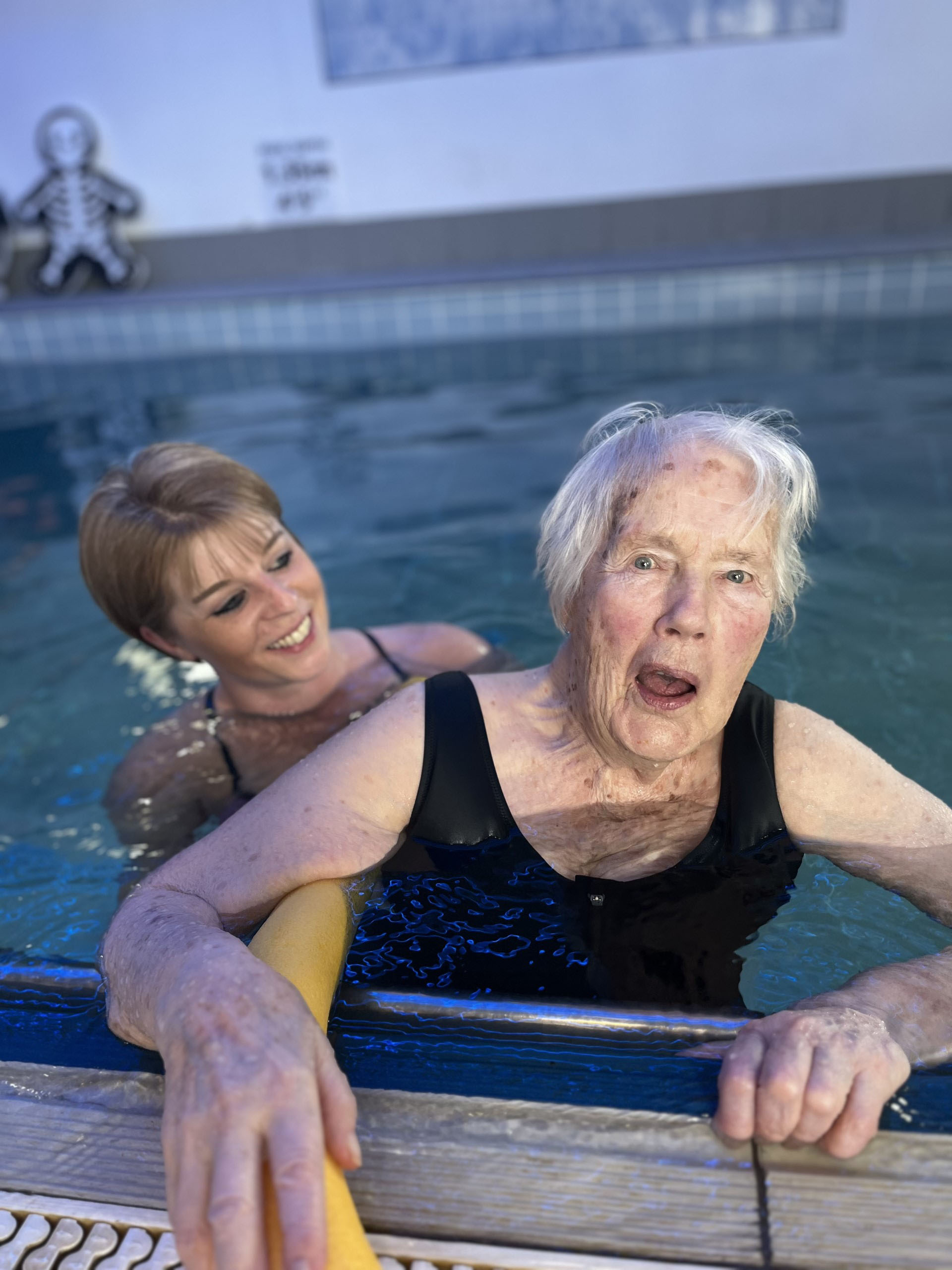 Joyce, right, enjoying her swim alongside care co-ordinator, Lucy England
