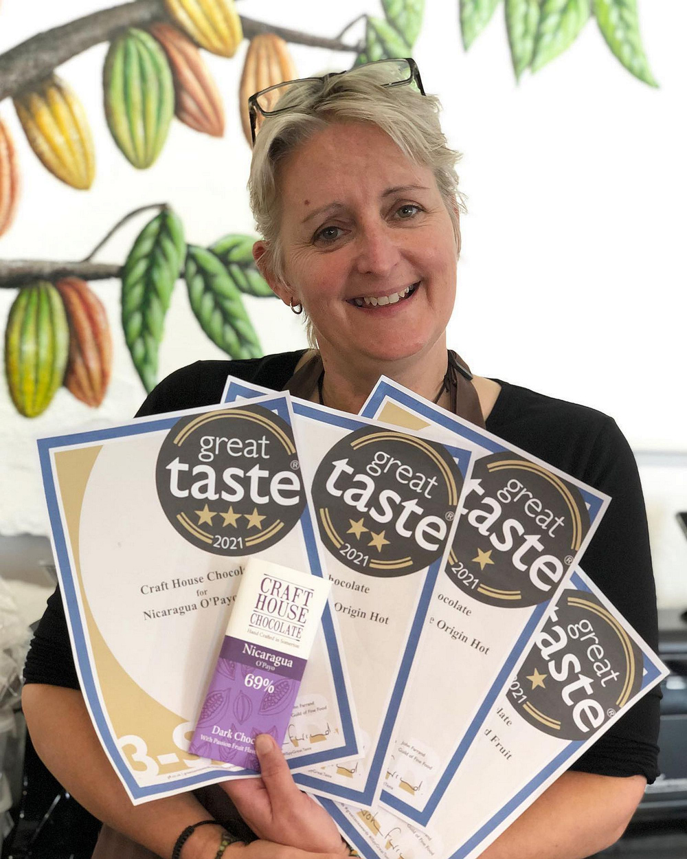 CHOC A BLOC: Netty Oakley-Prior with her certificates from the Great Taste Awards. Inset below: Cacao beans