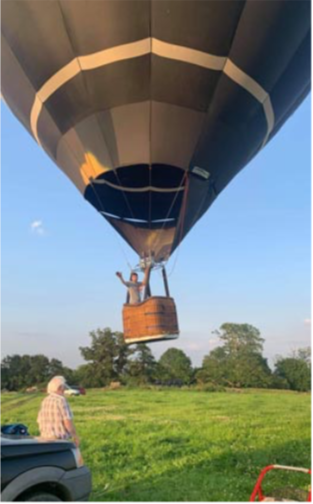 Alex Harvey waves goodbye to terra firma as he takes off in his hot air baloon