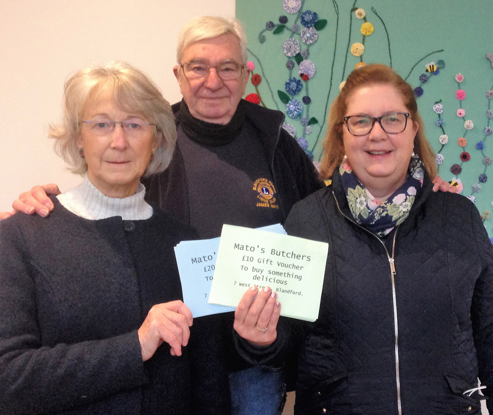 Jan Conlon from Stour Rotary, James Mayo of Blandford Lions Club and Food Bank manager Gail Del Pinto with the donated Mato’s vouchers