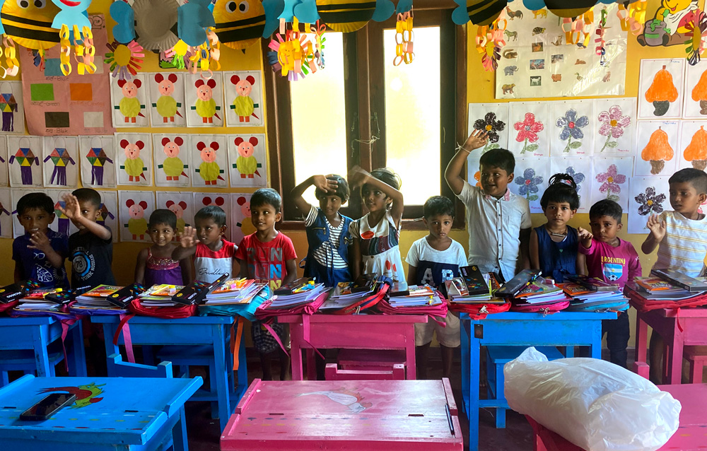 Some of the children at the Akurala Kindergarten receive their stationery supplies for the new school year prior to moving into the KFA charity’s brand-new building